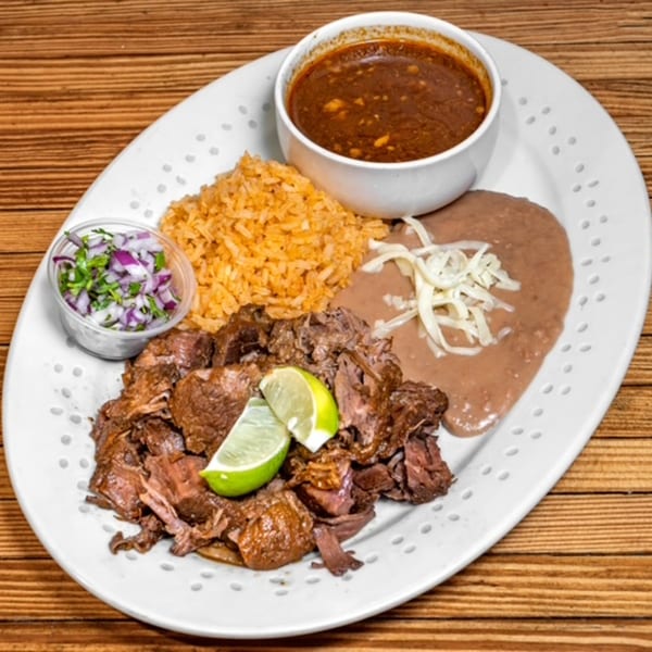 Los Cantaros Taqueria's Mexican dish with shredded beef, rice, refried beans, salsa, and lime.